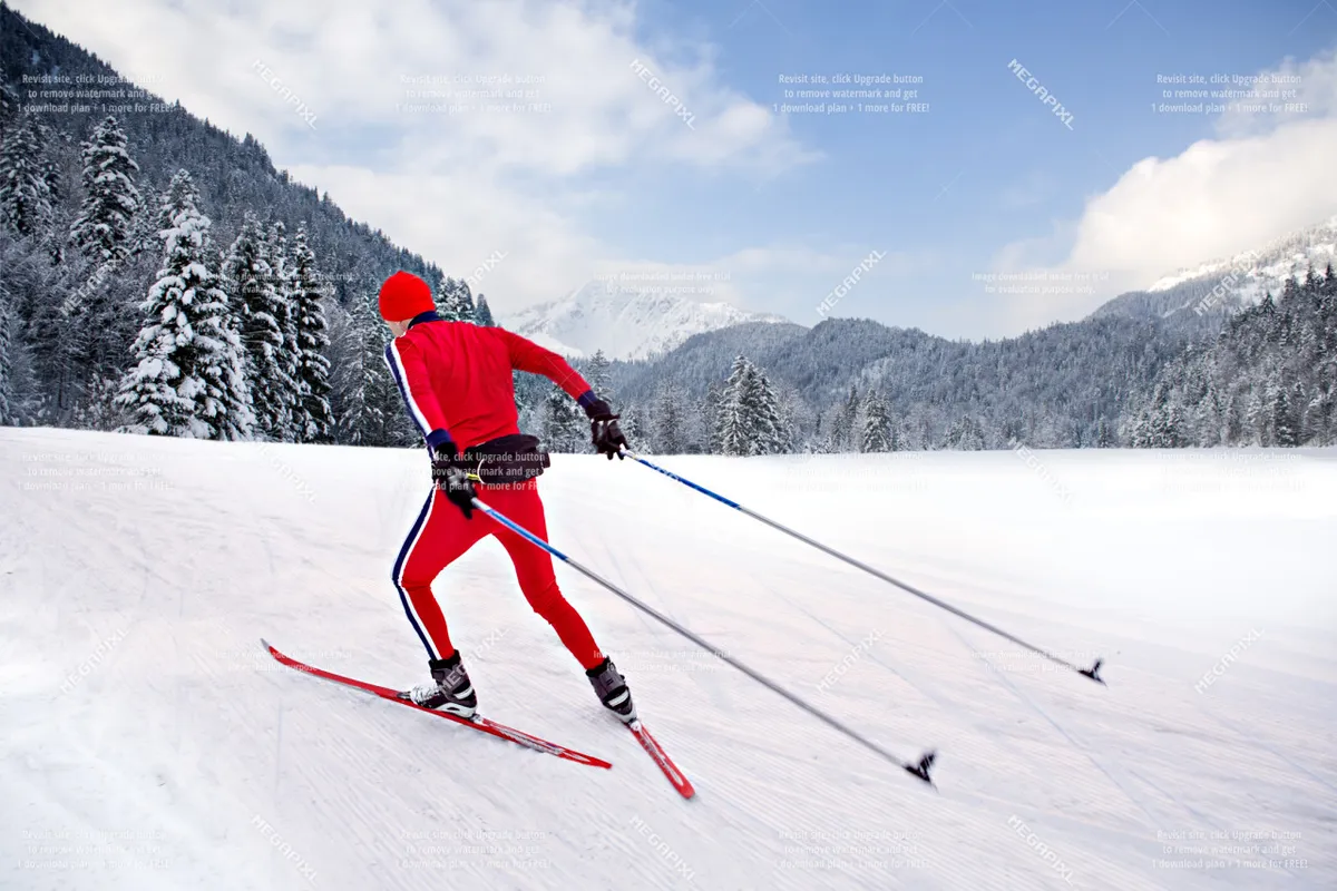 A dynamic scene featuring a skier gliding across a vast, snow-covered landscape. Pine trees and rugged mountains provide a dramatic winter backdrop, emphasizing the thrill and serenity of alpine adventures. The skier’s movement captures the excitement and energy of snow sports at Anthony Lakes.